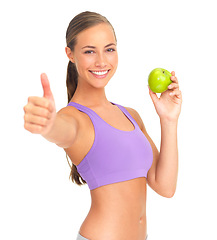 Image showing Woman, apple and thumbs up in studio portrait for health, nutrition or wellness by white background. Isolated model, healthy fruit or smile for diet goal, vitamin c or natural detox for strong body