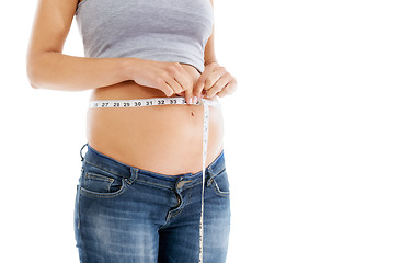 Image showing Pregnant, measuring tape and stomach in studio as woman check growth, development and health on mockup. Abdomen, wellness and pregnant woman self care, diet and healthy progress on white background