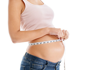 Image showing Pregnant woman, measuring tape and stomach on a white background to check growth, development and health. Abdomen, wellness and pregnancy for self care, diet and healthy progress goals on mock up