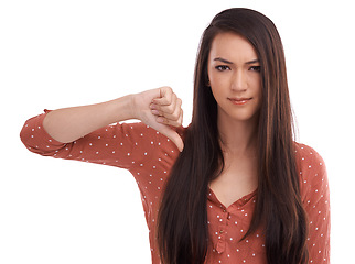 Image showing Woman, thumbs down and frowning in frustration, wrong or expression against a white studio background. Portrait of isolated female model pointing thumb down for negative, incorrect or displeased