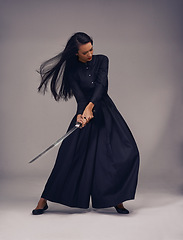 Image showing Samurai, sword and japanese woman fighter, ninja or warrior swing to fight for power, cosplay and fantasy. Asian female from Japan in black fashion with beauty, action and metal weapon for art deco