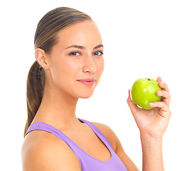 Image showing Nutrition, fruit and portrait of a woman with an apple for health on a white background in a studio. Food, smile and fitness trainer with fruits for vegan diet and lifestyle on a studio background