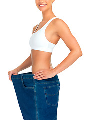 Image showing Health, weight loss and woman with jeans and tummy tuck with skinny waist, cropped and isolated on white background. Fitness, healthcare and wellness, girl with slim figure after liposuction or diet.