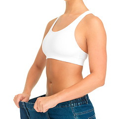 Image showing Diet, weightloss and woman holding jeans with thin waist, cropped and isolated on white background. Fitness, health and wellness, girl with slim figure and weight loss after liposuction progress.