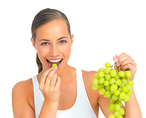 Image showing Health, diet and woman with grapes in a studio for a healthy snack, nutrition or craving. Wellness, weightloss and portrait of a young female model eating fruit while isolated by a white background.