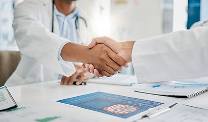 Image showing Closeup handshake, doctors and agreement for documents, research or health in hospital to stop virus. Doctor, shaking hands and motivation for healthcare service, wellness or teamwork goal in clinic