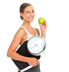 Image showing Health, fitness and woman with scale and apple for nutrition, weight loss and body care portrait isolated on white background. Food, exercise and wellness, weight and fruit, healthy diet motivation