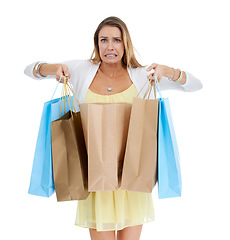 Image showing Woman, shopping and oops with bags in studio portrait with expenses, surprise and white background. Model, shopping bags and isolated regret for fashion, sale and discount for spending shopaholic