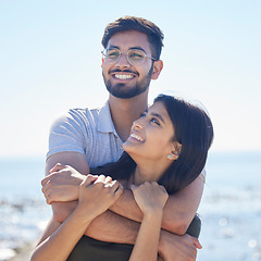Image showing Smile, hug and support with couple at beach, travel and care on summer holiday by ocean, commitment and love outdoor. Young, happy and relationship with romantic date, man and woman embrace on trip