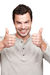 Image showing Young man, thumbs up and smile for winning, discount or sale against a white studio background. Portrait of a isolated handsome male giving thumbsup for agreement, yes or approval on white background