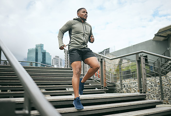 Image showing Exercise, stairs and black man training, city or workout for fitness, fresh air or wellness. Nigerian male, trainer or athlete on steps, prepare for competition or running for energy, power or cardio