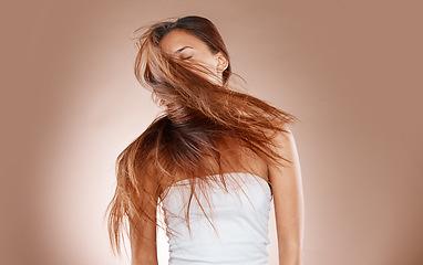 Image showing Hair care, beauty and cosmetics of a woman shaking her head on studio background for luxury keratin treatment. Headshot of aesthetic model posing for salon, luxury hairdresser and wellness mockup