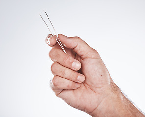 Image showing Man, hands or grooming hair tweezers on gray studio background in eyebrow self care, healthcare wellness or beauty aesthetic. Zoom, model or hair removal tool in facial cleaning or growth maintenance