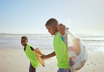 Image showing Children, beach and pollution with friends cleaning plastic or litter from the sand by the sea or ocean. Nature, recycle and environment with volunteer kids picking up trash, waste or garbage
