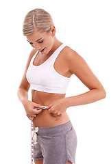 Image showing Health, fitness and woman with tape measure for abdomen in studio isolated on a white background. Diet, wellness and slim female model measuring waist to track weightloss goals, progress or targets.