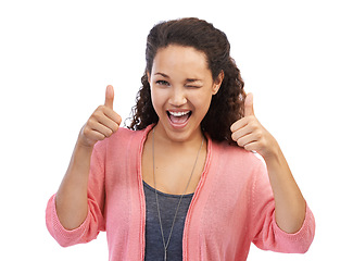 Image showing Face portrait, thumbs up and wink of woman in studio isolated on a white background. Hands gesture, like emoji or happy female model with sign for success, support or approval, thank you or agreement