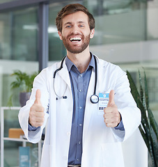 Image showing Thumbs up, healthcare and portrait of doctor success, thank you for support and trust with goal, target and wellness motivation. UK medical worker with like, support or thanks hands sign in hospital