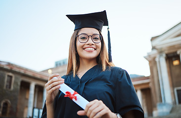 Image showing Portrait, graduate and study with a student woman holding a diploma or certificate outdoor on graduation day. Education, goal or unviersity with a female pupil outside after scholarship success