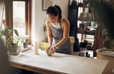 Image showing Creative, small business and pottery girl working with clay for idea, inspiration and art process. Creativity, business owner and asian woman focused at artistic workspace in Tokyo, Japan