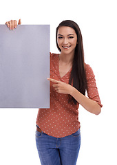 Image showing Mockup, portrait and woman pointing at poster, placard or billboard for promotion, advertising or product placement. Marketing sign, banner space or sales girl with studio mock up on white background