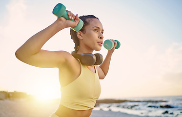 Image showing Health, woman and exercise on beach, fitness and workout for wellness, sports and training. Female, girl and athlete practice, seaside and healthy lifestyle for body care, headphones and weights.