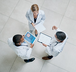 Image showing Top view, healthcare and doctors talking, brainstorming and share information. Medical professionals, men and woman with tablet, reports and conversation for surgery process in hospital and schedule.