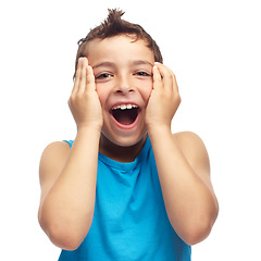 Image showing Portrait of adorable little boy touching face in surprise, isolated on white background in studio with copyspace. Cute child standing alone with mouth open in shock. Wow and amazed facial expression