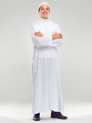 Image showing Islamic man, smile portrait and muslim fashion standing in white background for Arabic culture. Young person, smile and religion faith, worship or religious mindfulness standing isolated in studio
