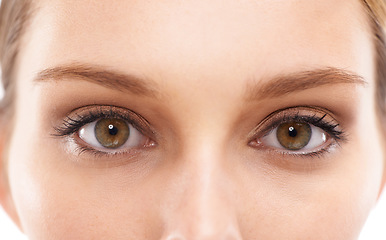 Image showing Face, eyes and vision with a woman in studio on a white background for eyecare or prescription eyewear. Microblading, makeup and zoom with a young female looking closeup while testing fher eyesight