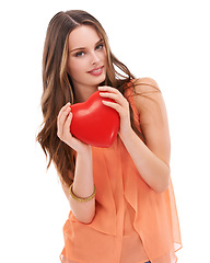 Image showing Portrait, heart and love with a woman in studio on a white background holding an emoji, icon or shape. Red, romantic and valentines day with a young female holding a symbol or romance in her hands