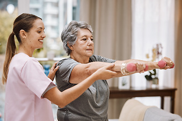 Image showing Women, senior or physiotherapy help with dumbbell in wellness clinic, healthcare center or nursing home living room. Smile, happy or physiotherapist nurse and elderly patient in weight rehabilitation