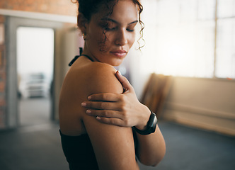 Image showing Woman, fitness and shoulder injury from sports workout, exercise or training at the gym indoors. Female holding arm after painful sport accident, inflammation or bruise from intense exercising