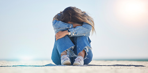 Image showing Sad woman, stress or depression by beach, sea environment or nature ocean with bipolar, loneliness or burnout. Mental health, anxiety or confused person crying with doubt, crisis fail or bad problem