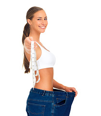 Image showing Diet, weightloss and happy woman with measuring tape, jeans and smile isolated on white background. Fitness, healthcare and wellness, woman with slim figure and liposuction skinny waist measurement.