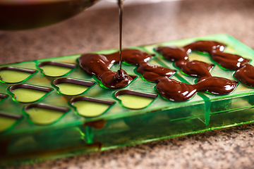 Image showing Putting chocolate in mold