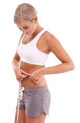 Image showing Fitness, health and woman with tape measure for abdomen in studio isolated on a white background. Diet, wellness and slim female model measuring waist to track weightloss goals, progress or targets.