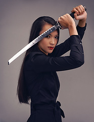 Image showing Portrait, sword and samurai with a model woman in studio on a gray background for martial arts or combat. Training, fantasy and weapon with an asian ninja ready to defend using self discipline