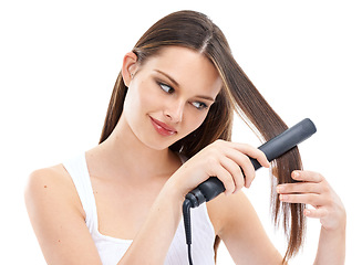 Image showing Woman, hair with hair straightener and beauty with hair care, electric cosmetic tools against studio background. Straight hair, keratin and treatment with hairstyle, shine with wellness and grooming