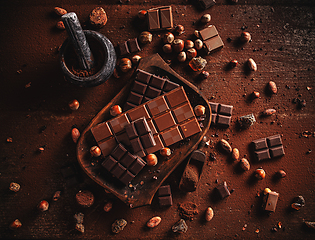 Image showing Cocoa powder, beans and chocolate bar pieces