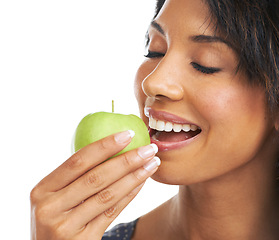 Image showing Woman, studio and apple with smile, nutrition and hungry for healthy, organic snack and eating by white background. Black woman, happy and natural green fruit for diet, energy or wellness by backdrop