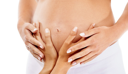 Image showing Hands, pregnant and mother with a woman in studio on a white background expecting a beautiful baby. Family, love and pregnancy with a female touching the belly of an expectant mom or parent