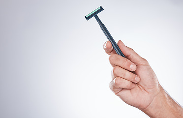 Image showing Grooming, shaving and hand with a razor for body hair, hygiene and clean shave on a studio background with mockup. Cleaning, equipment and model with a product for trimming hairs for wellness