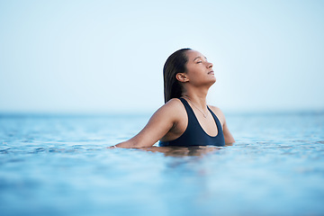 Image showing Sea, swimming and relax with a woman in nature, outdoor on holiday or vacation enjoying a swim in the ocean with mockup. Water, summer and freedom with a female swimmer outside for travel or tourism