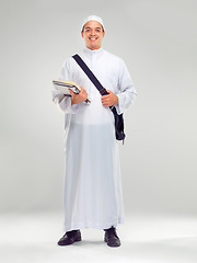 Image showing Young muslim man, islamic clothes and standing for religious studying, worship or spiritual happiness in white background. Arabic student, happy and religion fashion or culture isolated in studio