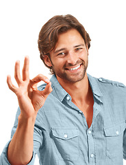 Image showing Man with smile, Ok hand sign and agreement in portrait, good review with feedback and emoji against studio background. Yes gesture, success and vote with approval and male voice positive opinion