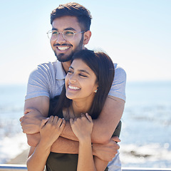 Image showing Love, ocean and happy couple hug, relax and enjoy outdoor quality time together for peace, freedom and romantic date. Beach, sea and man and woman bond on fun travel holiday in Rio de Janeiro Brazil