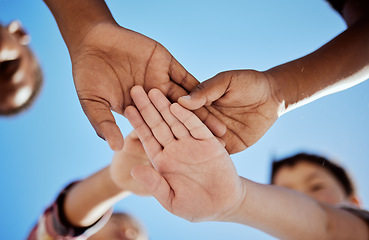 Image showing Diversity, stack of hands and children in unity, support or solidarity with a blue sky background. Solidarity, collaboration and multiracial kid friends cheering together for motivation, fun and joy.