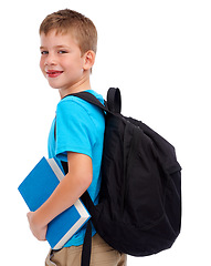 Image showing Boy child, studio portrait and backpack with book, smile and happiness for education goal by white background. Isolated student kid, learning and school with smile, happy and ready to start reading