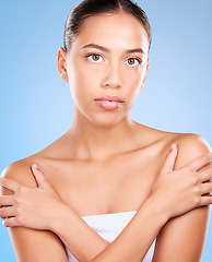 Image showing Skincare, beauty and portrait of a woman in a studio for natural, self care and body care treatment. Health, wellness and girl model from Brazil with a facial routine isolated by a blue background.