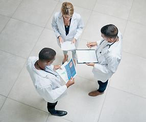 Image showing Top view, healthcare and doctors talking, brainstorming and share information. Medical professionals, men and woman with tablet, reports and conversation for surgery process in hospital and schedule.